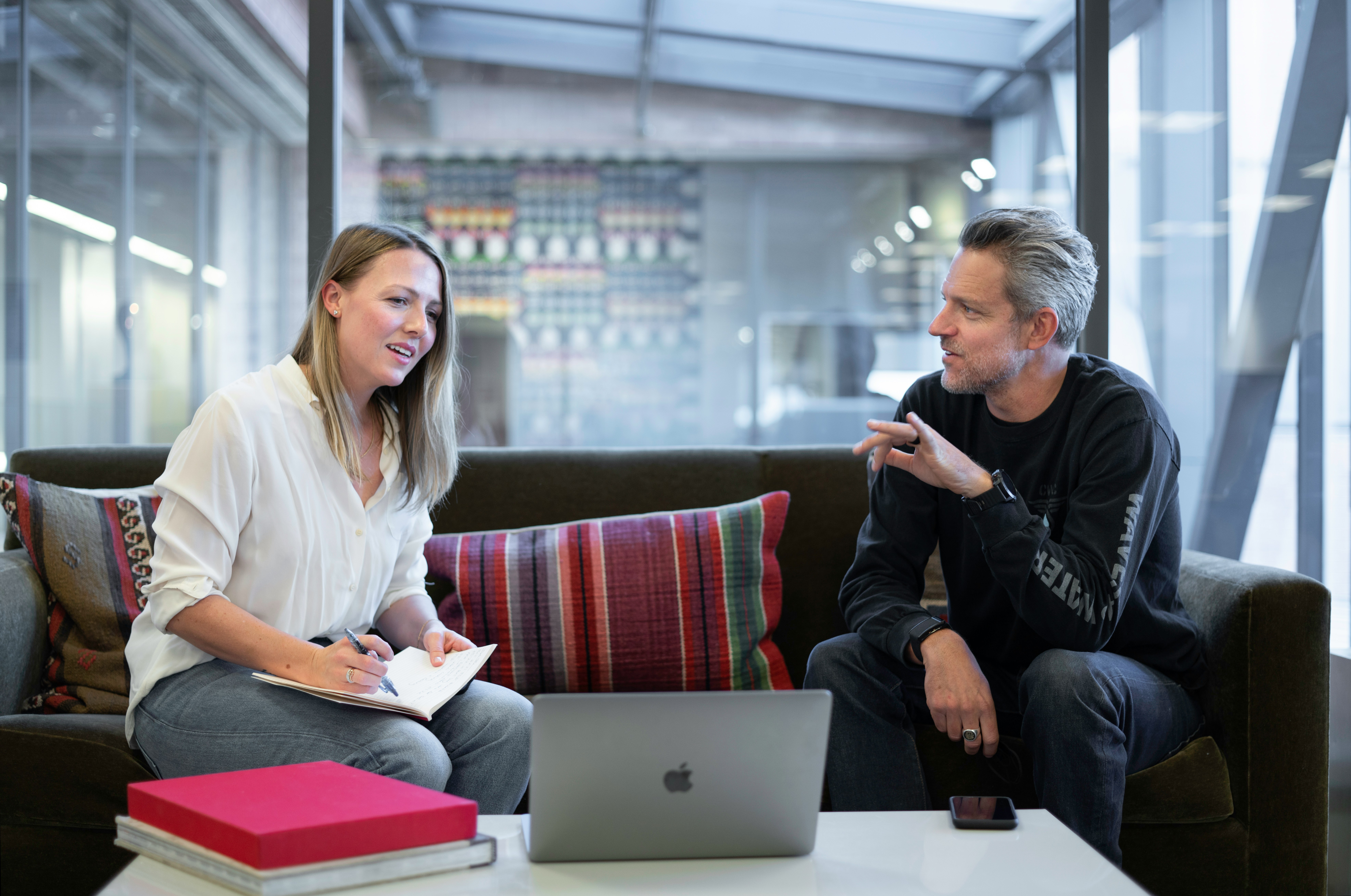 Woman and man in a meeting with laptop on the table