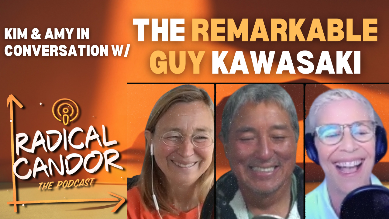 two women, both in headphones and a man in the middle all smiling