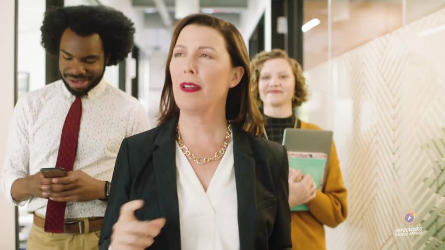 Manager walking down the hallway with her team
