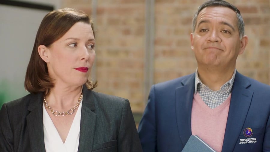 Two colleagues, one holding back what he thinks