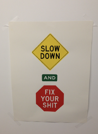 Photo of a 'Slow down and fix your shit' sign posted at a former Facebook office