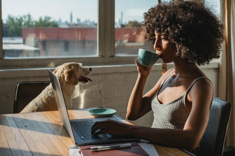 What Does Gen Z Want At Work? A Woman Drinking Coffee At Hr Computer.
